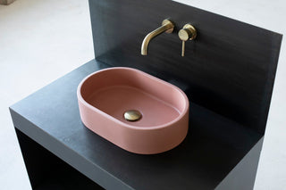 oval pink concrete vessel sink